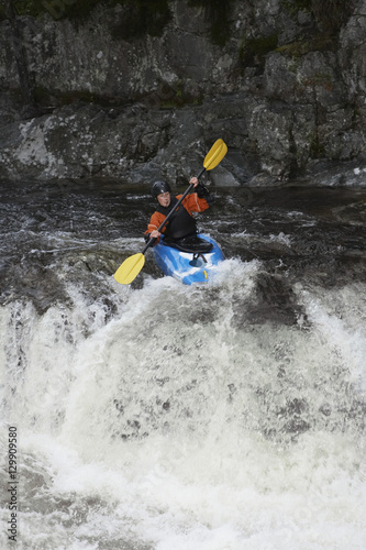 View of a woman kayaking in rough river © moodboard