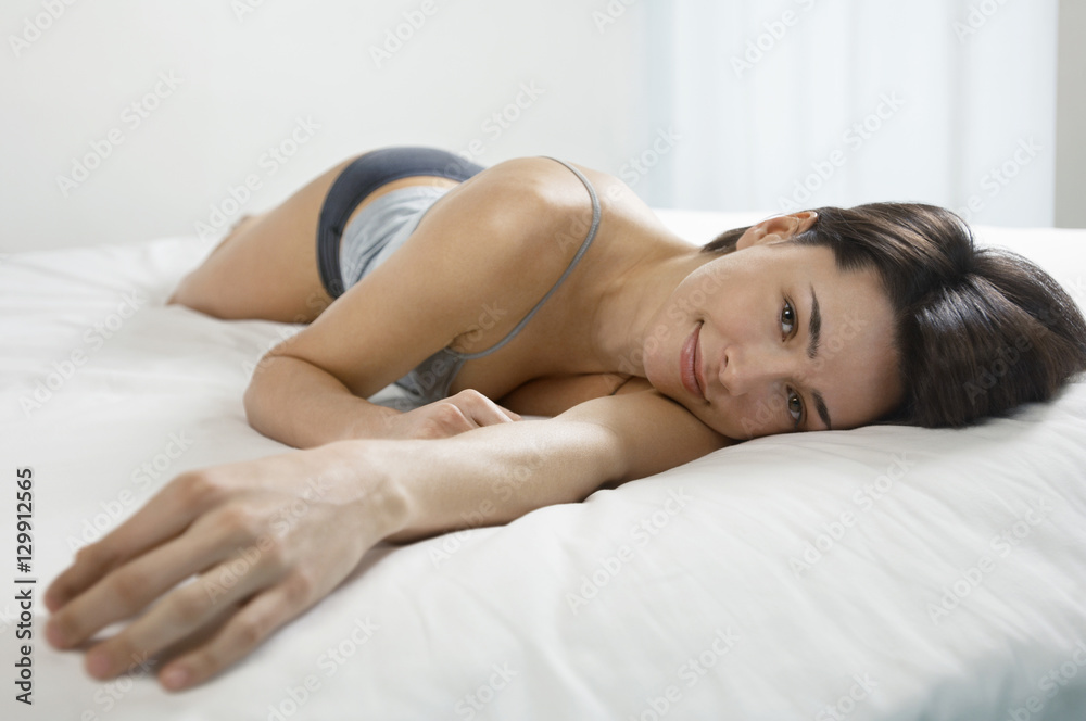 Portrait of a beautiful young woman lying in bed Portrait of a beautiful young woman lying in bed