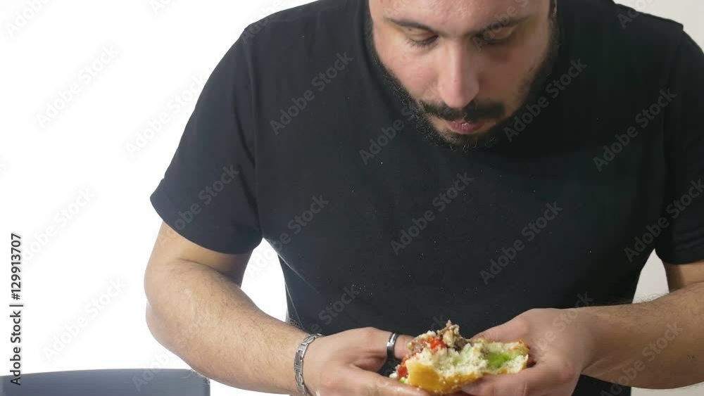 a hungry man devouring a hamburger a hungry man devouring a hamburger
