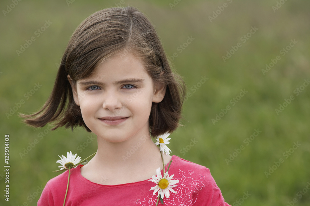 Closeup portrait of cute girl wearing garland in meadow Closeup portrait of cute girl wearing garland in meadow