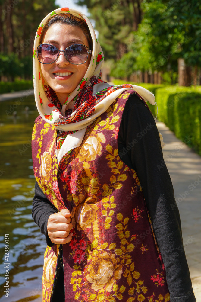 Young Iranian woman in fashionable modern clothes, Bagh-e Dolat garden, Yazd, Iran Young Iranian woman in fashionable modern clothes, Bagh-e Dolat garden, Yazd, Iran