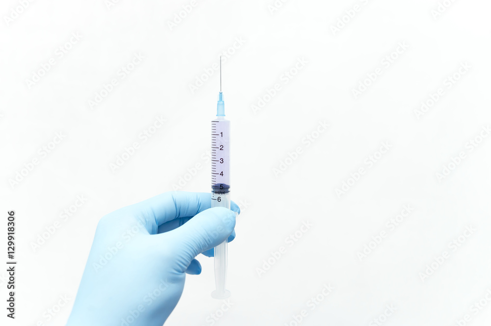 Doctor holds a syringe for vaccine injection Doctor holds a syringe for vaccine injection