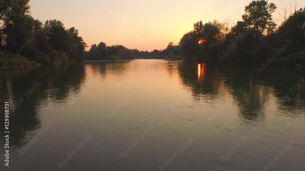 AERIAL, CLOSE UP: Stunning glossy river surface reflecting golden sky AERIAL, CLOSE UP: Stunning glossy river surface reflecting golden sky