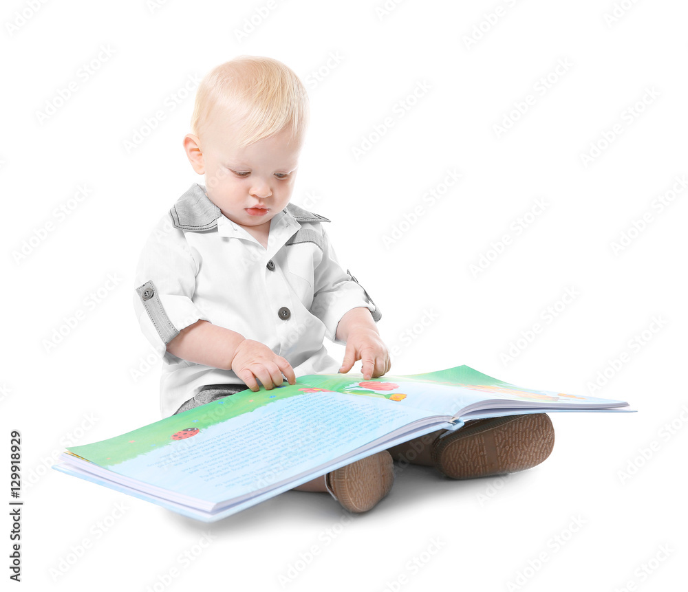 Baby boy with book sitting on white background Baby boy with book sitting on white background