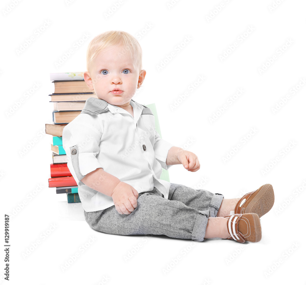 Baby boy with books on white background