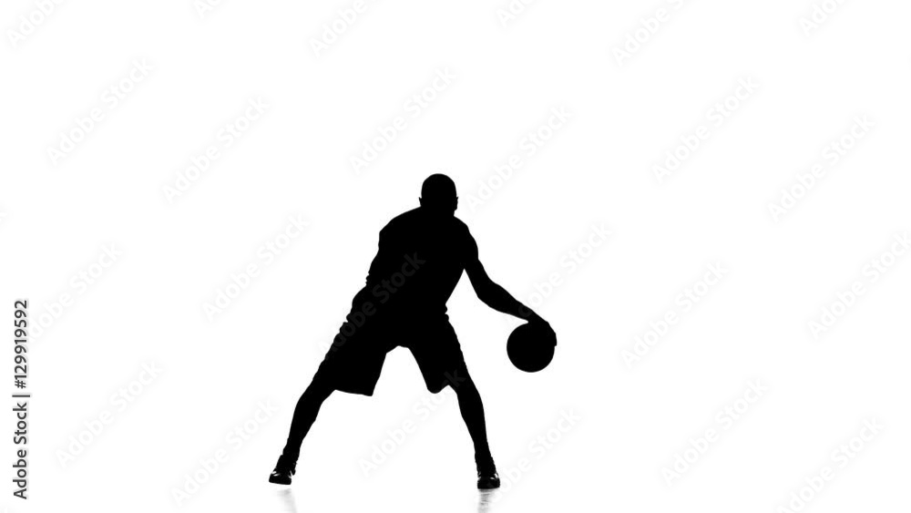 Boy basketball player skillfully handles the ball. Silhouette. White background