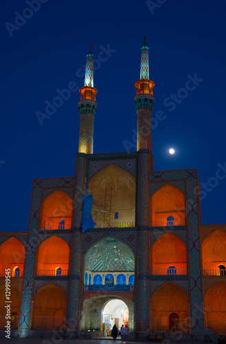 Amir Chakhmagh Complex floodlit with moon, Yazd, Iran photo