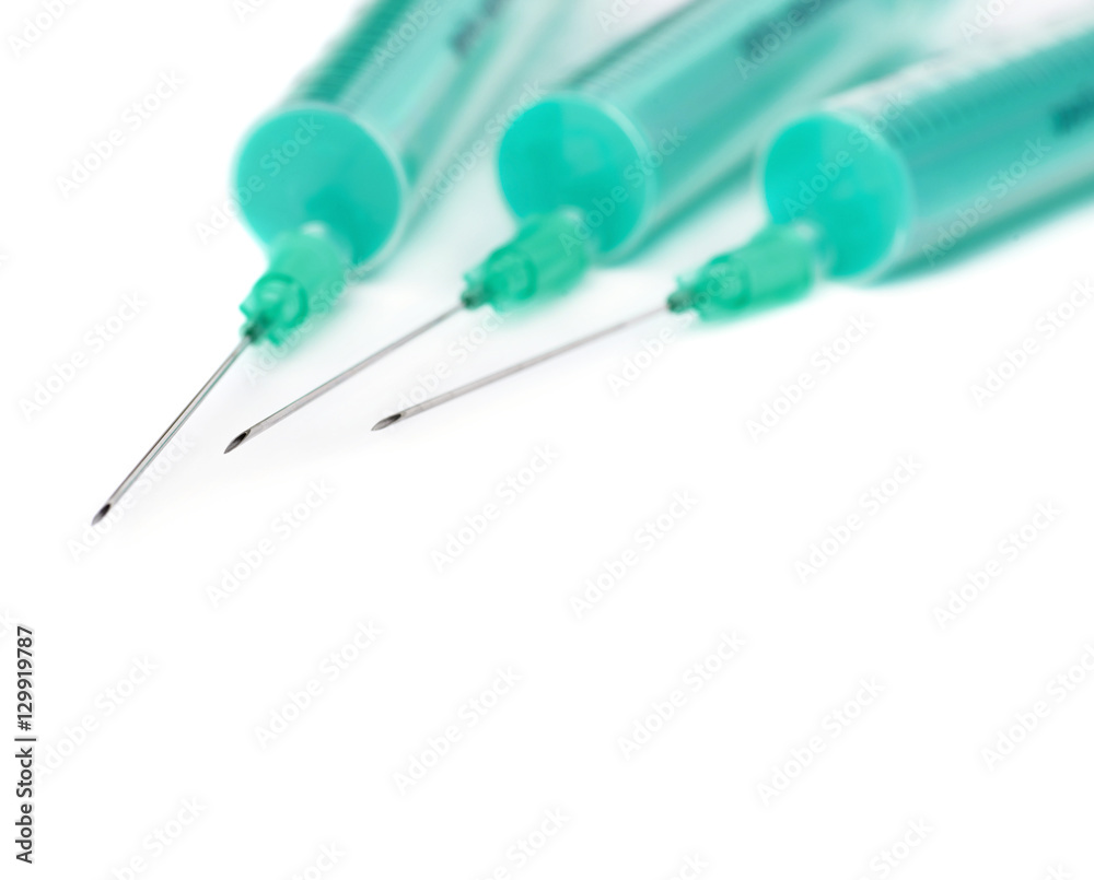 Medical syringes with needles lying isolated over white background Medical syringes with needles lying isolated over white background