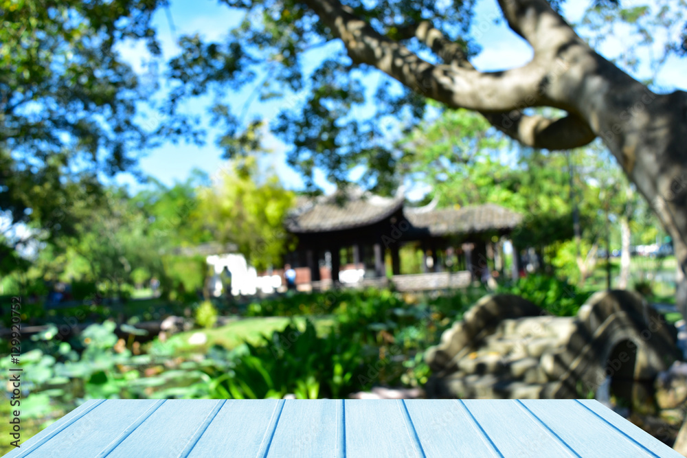 Empty top blue wooden table and chinese pavilion abstract blurred background, Can use for product display. Empty top blue wooden table and chinese pavilion abstract blurred background, Can use for product display.