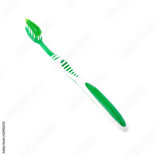 Green toothbrush with paste isolated over white background