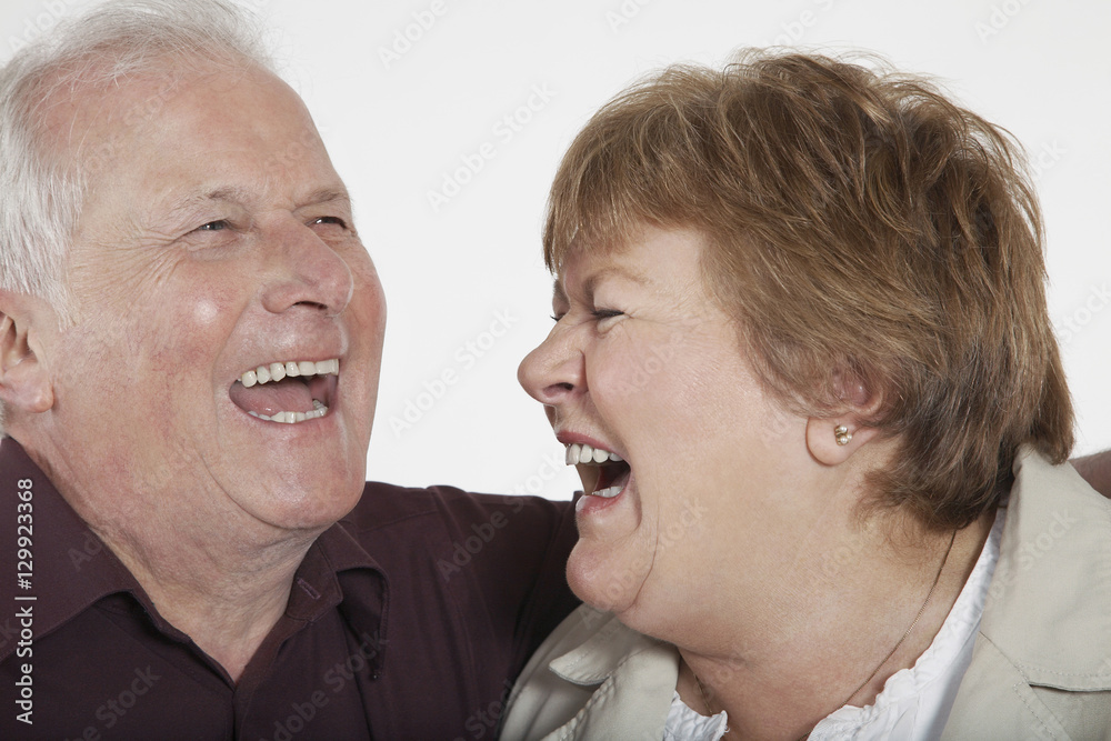 Closeup of senior couple laughing on white background Closeup of senior couple laughing on white background