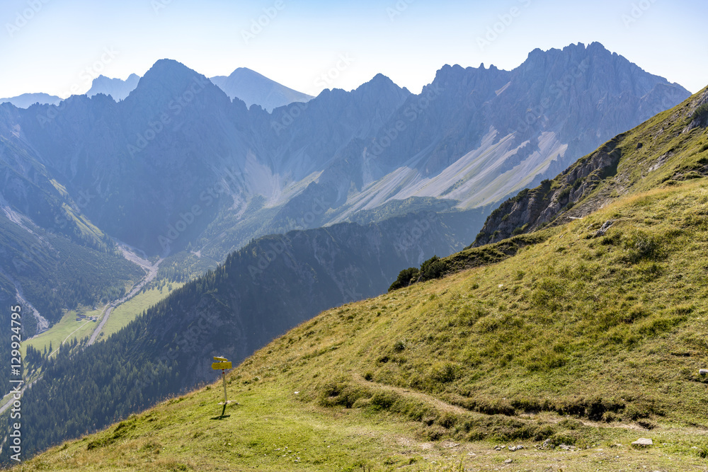 Steep alpine mountains with forested valleys