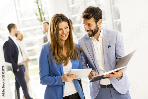 Young business couple using tablet in the office