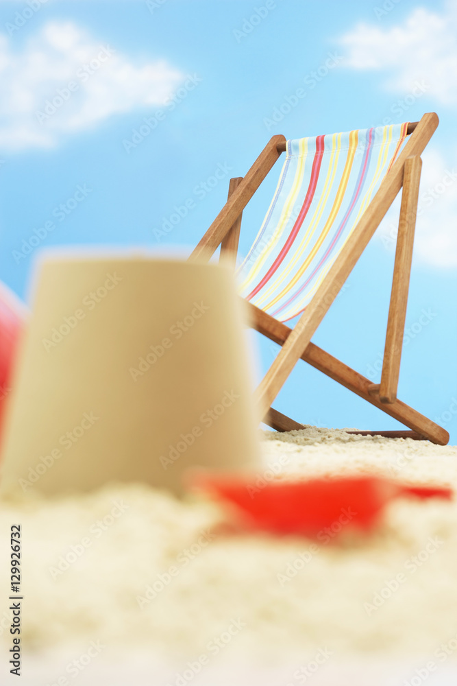 Deck chair behind and castle on beach Deck chair behind and castle on beach