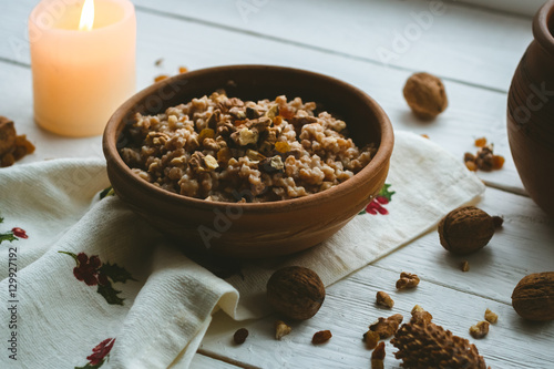 Christmas porridge with candles on white wooden background photo