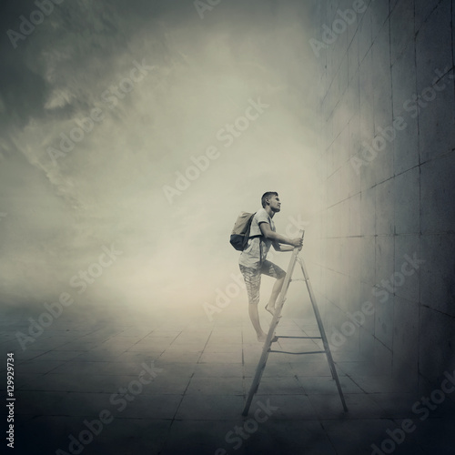 Abstract idea with a person climbing a ladder, in front of a concrete wall with no exit. Surrounded by limitations, daily routine.