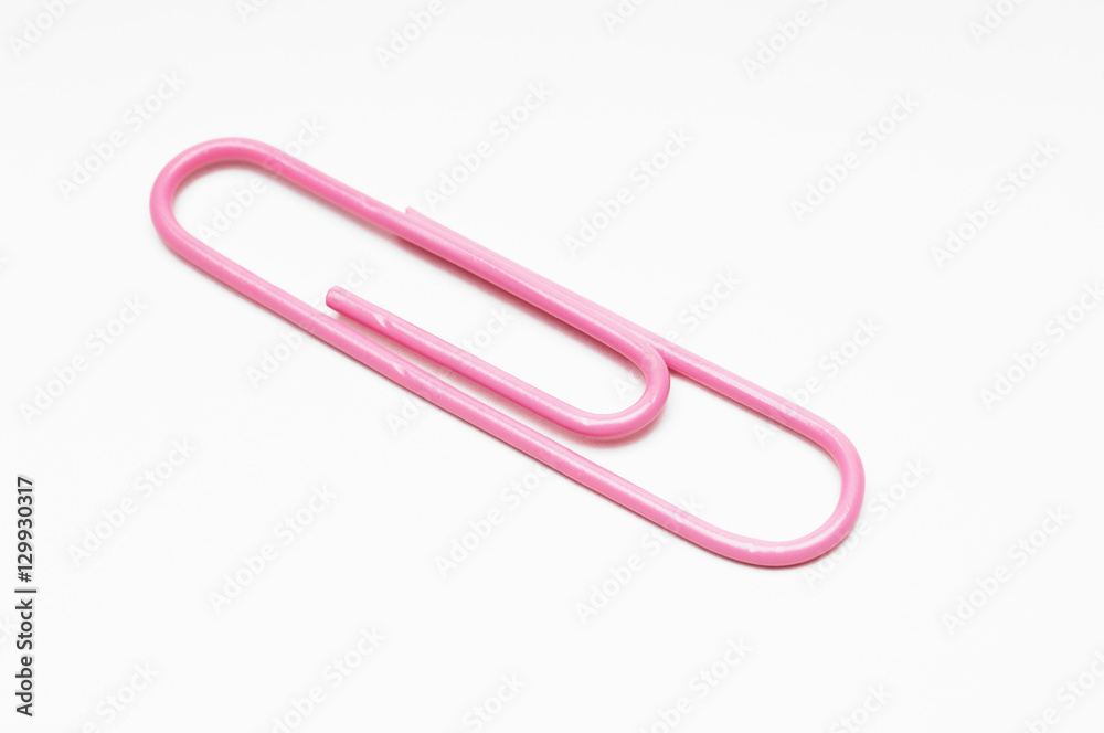 Closeup of pink paperclip over white background Closeup of pink paperclip over white background
