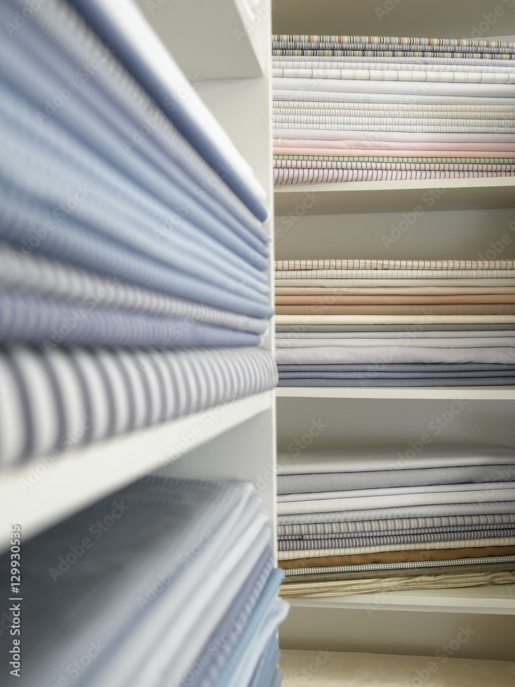 Piles of cotton fabric on shelfs Piles of cotton fabric on shelfs