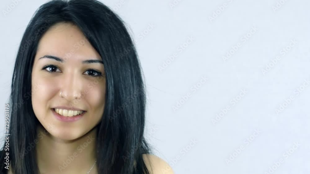 young smiling woman looking in camera and entering the frame from bottom young smiling woman looking in camera and entering the frame from bottom