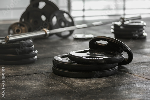 Disassembled barbell on floor in gym