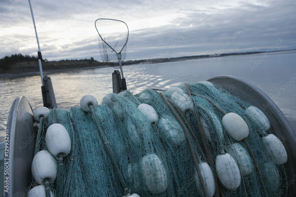 Commercial fishing net on back of a fishing boat at dusk Stock Photo