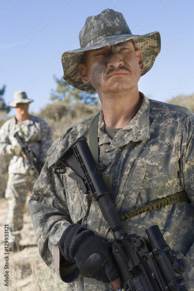 Armed US army soldiers with machine guns in field