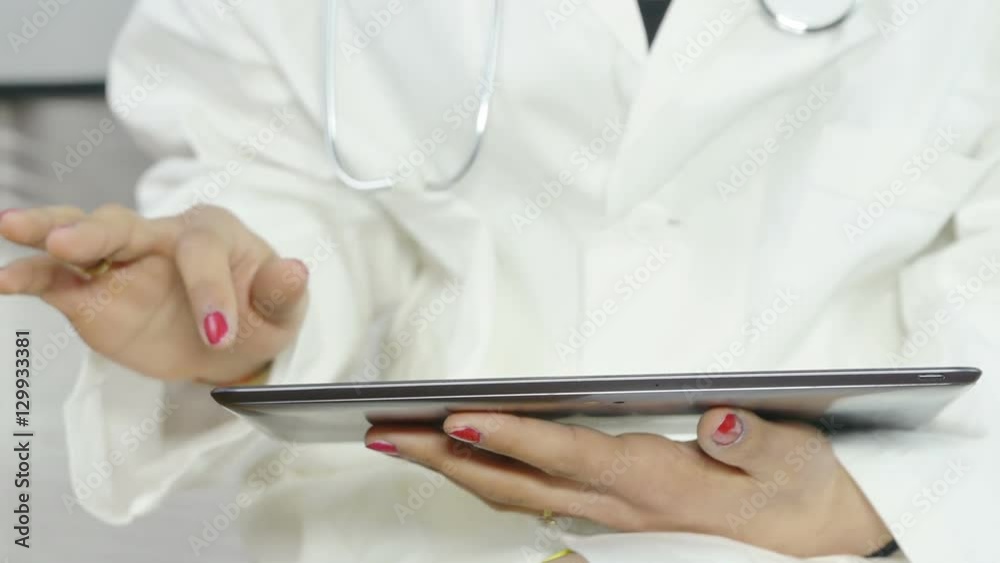 young female doctor using a tablet computer at work