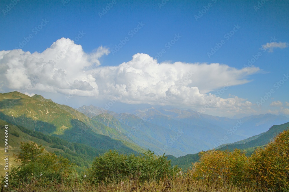 Fototapeta premium Summer mountain landscape with cumulus cloud