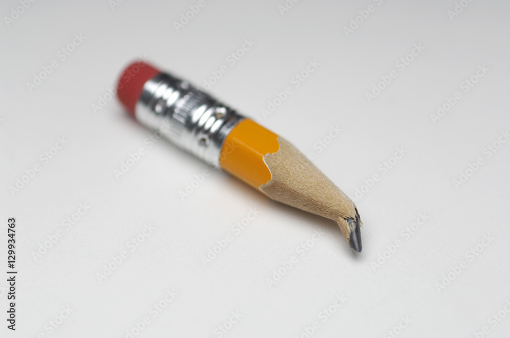 Closeup of small broken pencil tip over white background Closeup of small broken pencil tip over white background