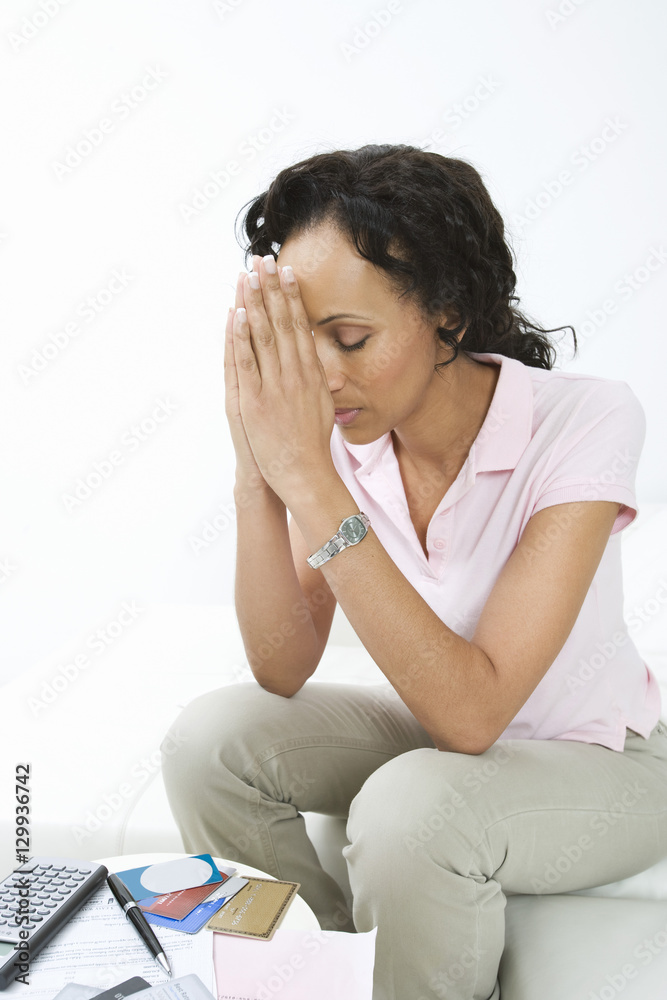 An African American woman worried about bills at home An African American woman worried about bills at home