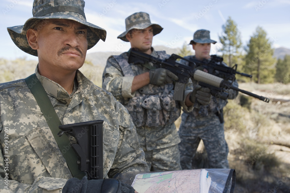 Three US army soldiers with machine guns during training Three US army soldiers with machine guns during training
