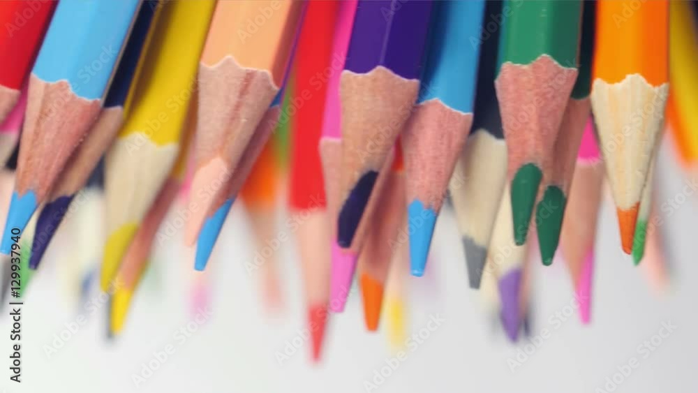Many wooden pencils of mixed colors point down with sharp ends, brightness, creativity, art, variety. Closeup, seamless loop, rotation, shallow DOF, 4K Ultra HD.