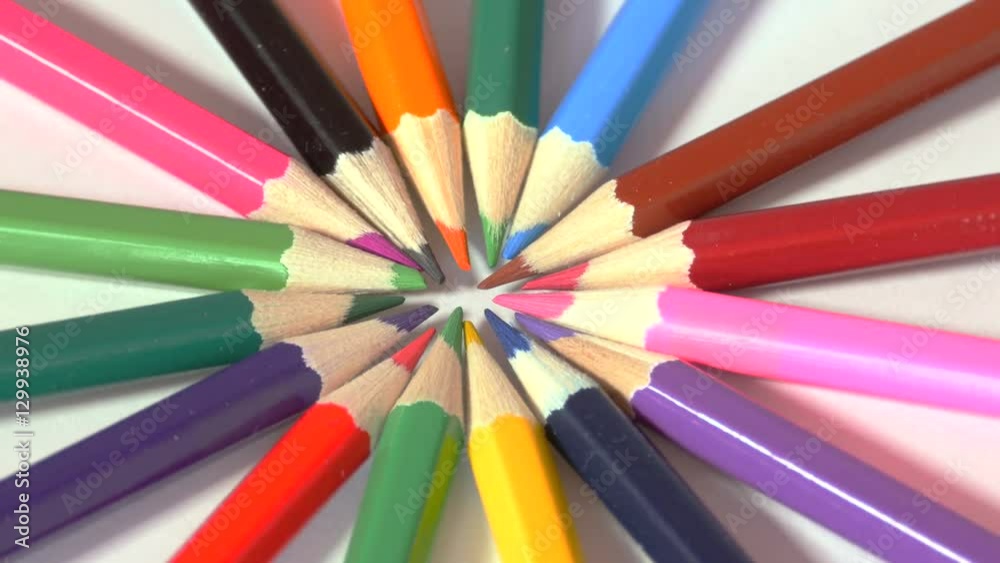 Wooden pencils of different colours are set in circle on white surface, colorful art, bright red, green, yellow, pink, purple, blue, green. Close up, seamless loop, rotation, 4K Ultra HD. Wooden pencils of different colours are set in circle on white surface, colorful art, bright red, green, yellow, pink, purple, blue, green. Close up, seamless loop, rotation, 4K Ultra HD.