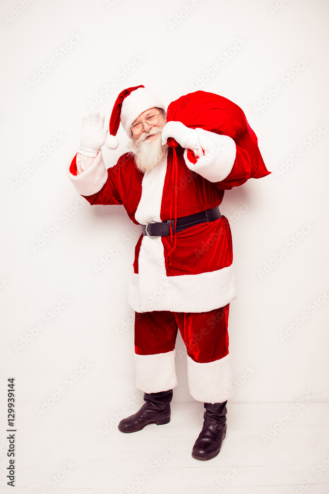 Happy Santa Claus carrying huge bag with xmas presents Happy Santa Claus carrying huge bag with xmas presents