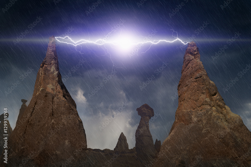 Powerful lightning discharges between peaks of two rocks in dark