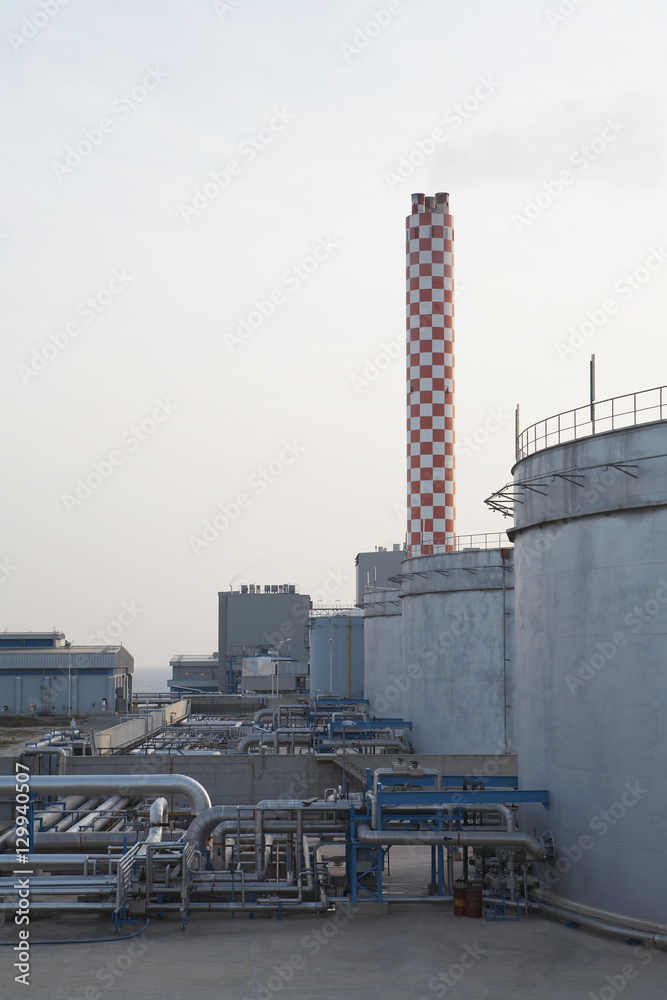 Fuel depot and smokestack at oil fired power station Fuel depot and smokestack at oil fired power station