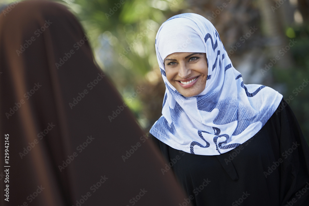 Two Indian Muslim women looking at each other Two Indian Muslim women looking at each other