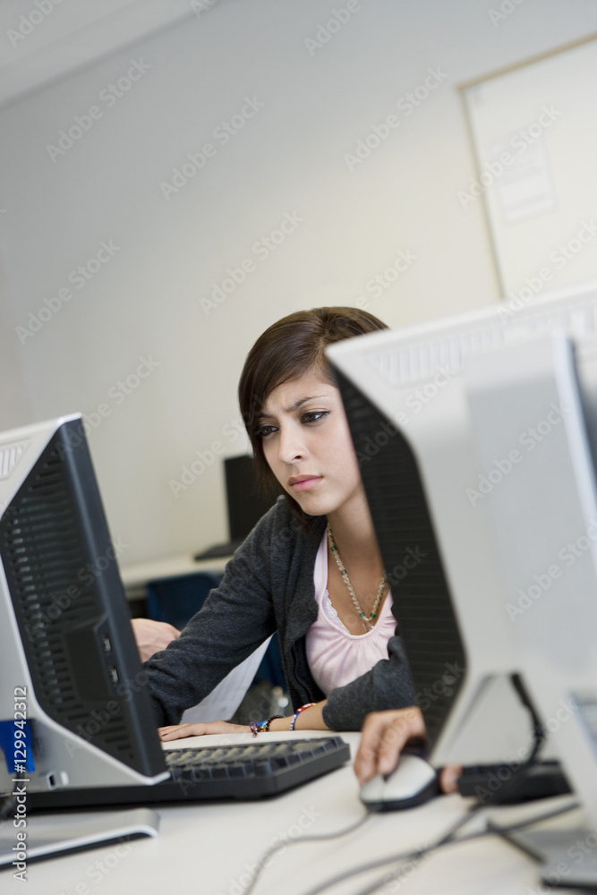 Beautiful young high school student in computer lab Beautiful young high school student in computer lab