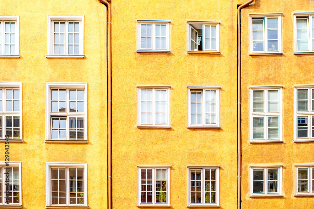 Yellow facade with windows of the old building in Gdansk, Poland