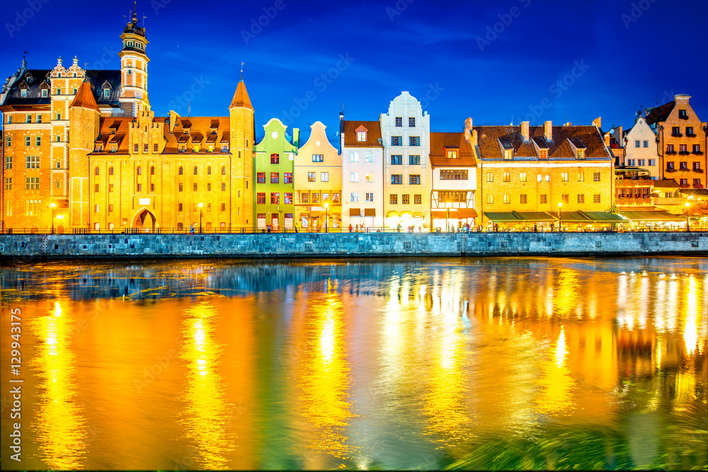 Night view on the illuminated riverside with beautiful buildings of the old town in Gdansk, Poland Night view on the illuminated riverside with beautiful buildings of the old town in Gdansk, Poland