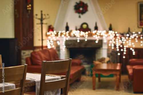 Cozy Christmas home interior with blurred fireplace and bokeh on the background