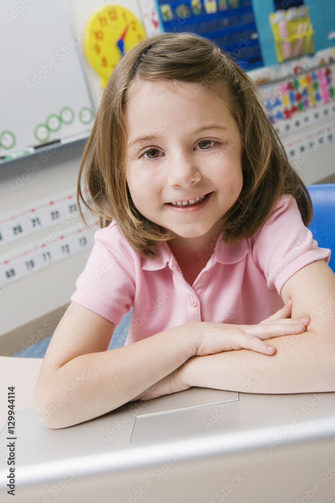 Portrait of a happy little girl using laptop in the classroom Portrait of a happy little girl using laptop in the classroom