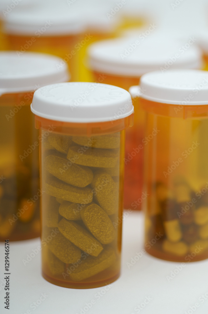 Closeup of pill bottles on white background Closeup of pill bottles on white background
