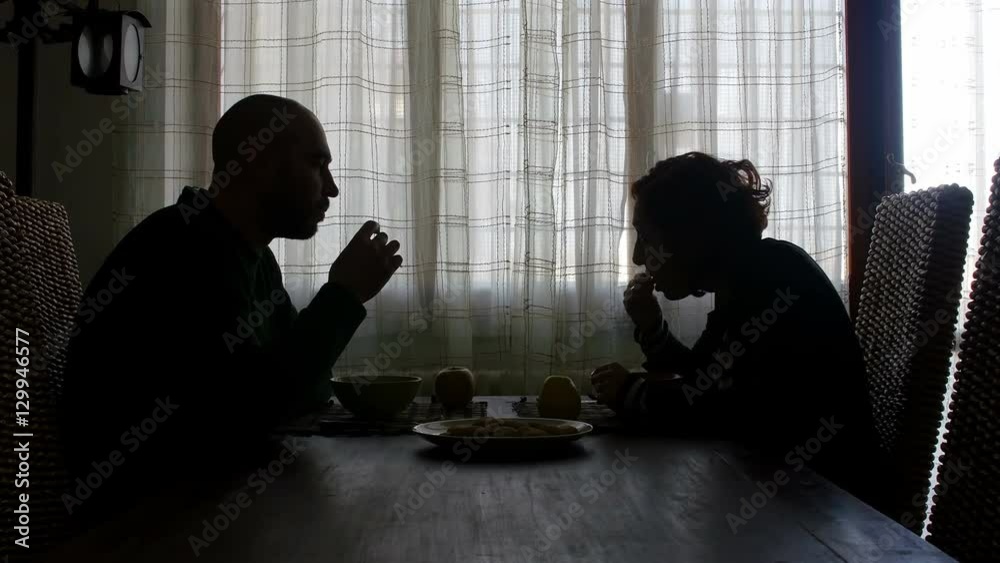 couple have breakfast in the morning, talking, milk and biscuits