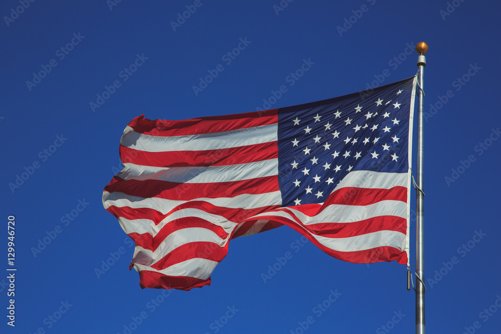 United States of America flag waving in blue sky