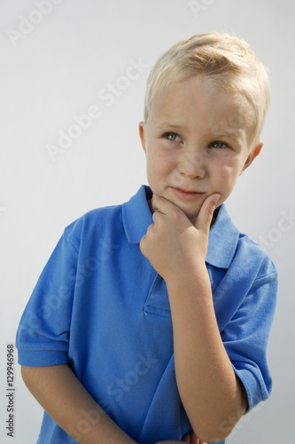 Young boy lost in thoughts isolated over white background
