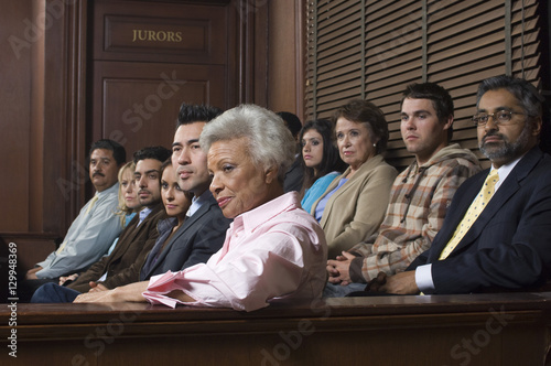Diverse group of jurors sitting in jury box of a courtroom photo