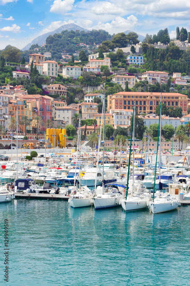 colorful houses and yachts in Menton old town harbour, France
