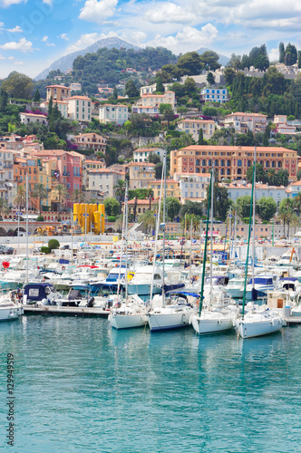 colorful houses and yachts in Menton old town harbour, France