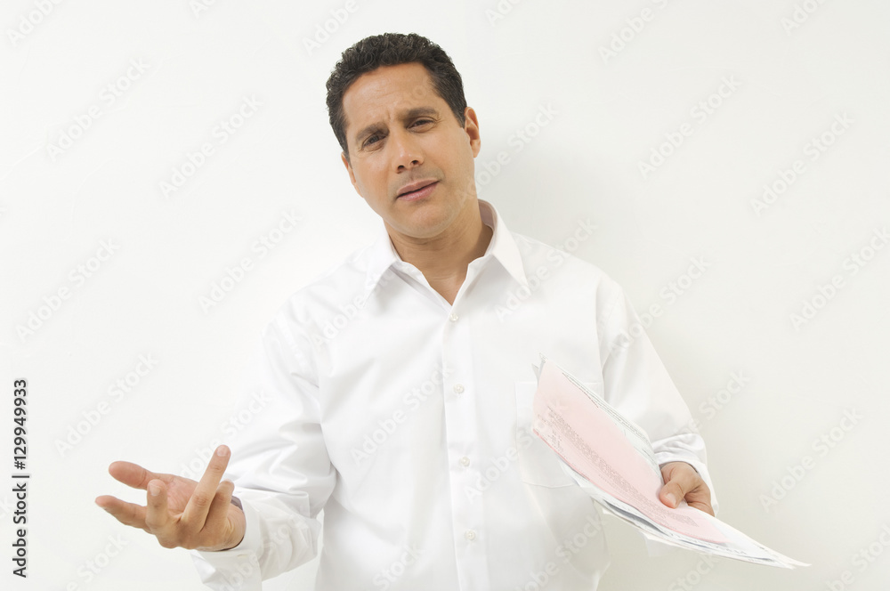 Portrait of a frustrated businessman with documents isolated over white background Portrait of a frustrated businessman with documents isolated over white background
